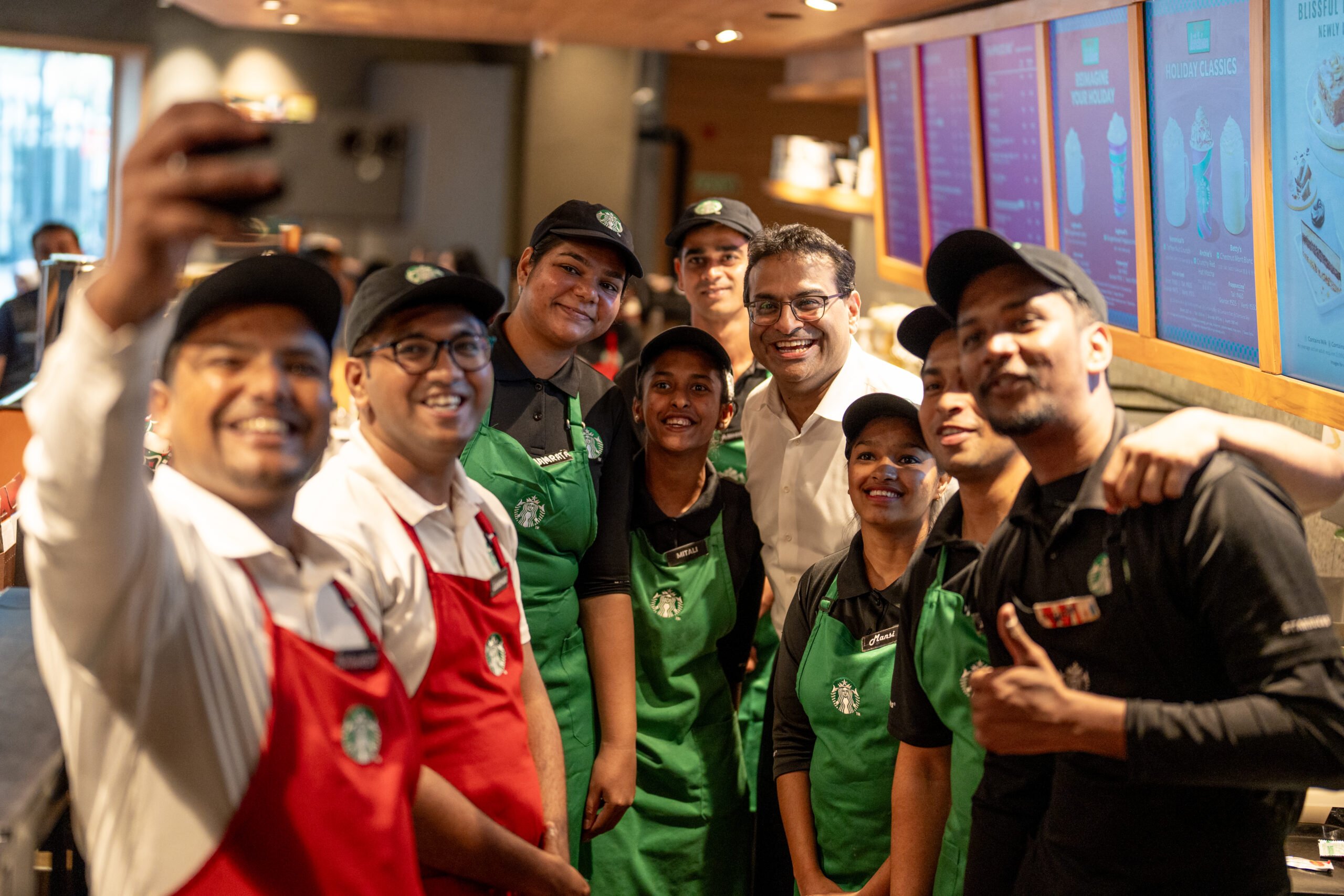 Starbucks CEO Laxman Narasimhan with green apron partners in India